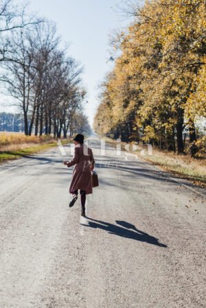 Young redhead lady woman in pink vintage coat and hat with suitcase - Art Liga Pictures